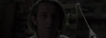 Movie still from “Post Mortem” (2010), directed by Pablo Larraín – A person wearing a white shirt; Close Up shot, Over the shoulder angle