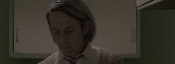 Movie still from “Post Mortem” (2010), directed by Pablo Larraín – A person with long hair; Close Up shot, Low angle