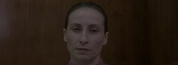 Movie still from “Post Mortem” (2010), directed by Pablo Larraín – A person's face in a dark room; Close Up shot, Low angle