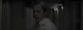 Movie still from “Post Mortem” (2010), directed by Pablo Larraín – A person with long hair; Close Up shot, Over the shoulder angle