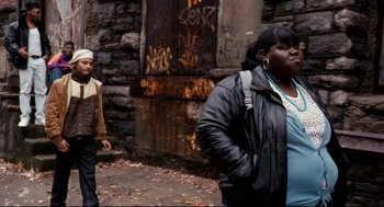 Movie still from “Precious” (2009), directed by Lee Daniels – A man and a woman walking down a street; Medium shot, Over the shoulder angle