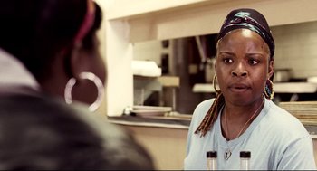 Movie still from “Precious” (2009), directed by Lee Daniels – A woman with dreadlocks talking to another person; Close Up shot, Over the shoulder angle