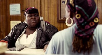 Movie still from “Precious” (2009), directed by Lee Daniels – A woman sitting at a table in front of a mirror; Medium shot, Over the shoulder angle