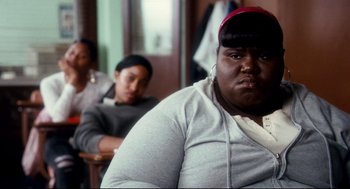 Movie still from “Precious” (2009), directed by Lee Daniels – A man sitting in front of another man in a room; Close Up shot, Over the shoulder angle