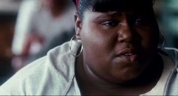 Movie still from “Precious” (2009), directed by Lee Daniels – A person wearing a jacket; Close Up shot, Over the shoulder angle