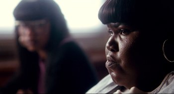 Movie still from “Precious” (2009), directed by Lee Daniels – A person sitting in front of another person; Close Up shot, Over the shoulder angle