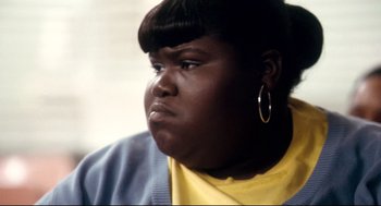 Movie still from “Precious” (2009), directed by Lee Daniels – A person wearing a yellow shirt; Close Up shot, High angle