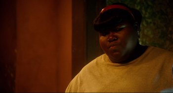 Movie still from “Precious” (2009), directed by Lee Daniels – A person with a hat and a shirt on; Close Up shot, Over the shoulder angle