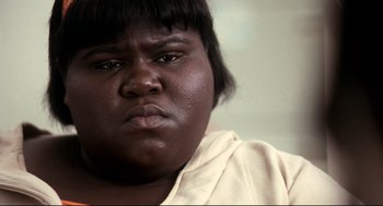 Movie still from “Precious” (2009), directed by Lee Daniels – A person's face with a frowning expression; Close Up shot, High angle