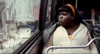 Movie still from “Precious” (2009), directed by Lee Daniels – A woman sitting on a bus looking out the window; Close Up shot, Low angle
