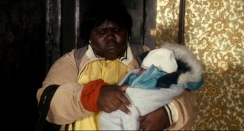 Movie still from “Precious” (2009), directed by Lee Daniels – A woman holding a baby in her arms; Close Up shot, High angle