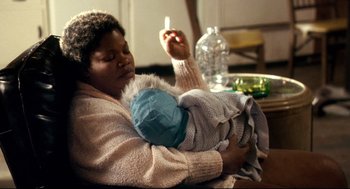 Movie still from “Precious” (2009), directed by Lee Daniels – A woman is holding a baby in her arms; Close Up shot, Over the shoulder angle