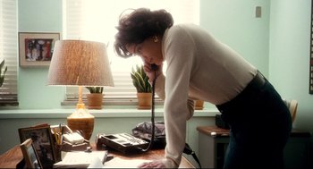 Movie still from “Precious” (2009), directed by Lee Daniels – A woman on the phone leaning over a desk; Medium shot, Low angle