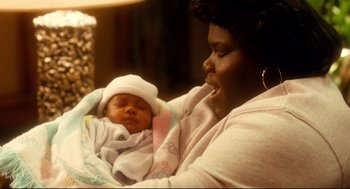 Movie still from “Precious” (2009), directed by Lee Daniels – A woman holding a baby in her arms; Close Up shot, High angle