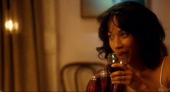 Movie still from “Precious” (2009), directed by Lee Daniels – A woman holding a glass of wine in her hand; Close Up shot, Over the shoulder angle