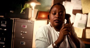 Movie still from “Precious” (2009), directed by Lee Daniels – A woman holding a phone up to her ear; Close Up shot, High angle