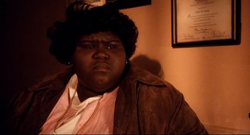 Movie still from “Precious” (2009), directed by Lee Daniels – A person wearing a jacket and a hat; Close Up shot, High angle