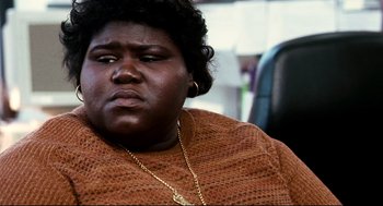 Movie still from “Precious” (2009), directed by Lee Daniels – A person wearing a brown sweater; Close Up shot, High angle