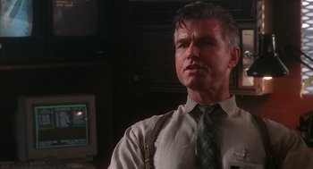 Movie still from “Predator 2” (1990), directed by Stephen Hopkins – A person wearing a shirt and a tie; Close Up shot, Low angle