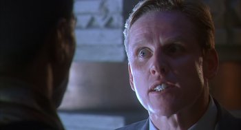 Movie still from “Predator 2” (1990), directed by Stephen Hopkins – A person talking to another person; Close Up shot, Low angle