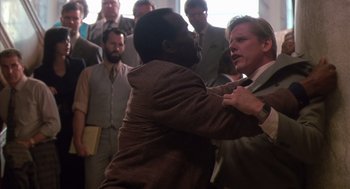 Movie still from “Predator 2” (1990), directed by Stephen Hopkins – A man in a brown jacket and a man in a white jacket; Medium shot, Over the shoulder angle
