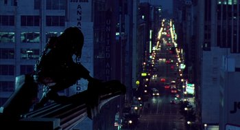 Movie still from “Predator 2” (1990), directed by Stephen Hopkins – A view of a city at night from a balcony; Wide shot, Low angle