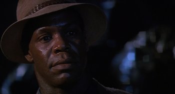 Movie still from “Predator 2” (1990), directed by Stephen Hopkins – A person wearing a hat; Close Up shot, Low angle