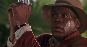 Movie still from “Predator 2” (1990), directed by Stephen Hopkins – A person holding a camera; Close Up shot, Low angle