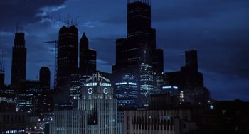 Movie still from “Predator 2” (1990), directed by Stephen Hopkins – A view of a city skyline at night time; Extreme Wide shot, High angle