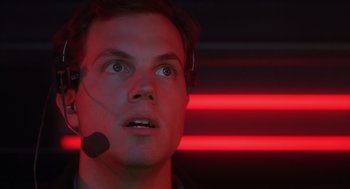 Movie still from “Predator 2” (1990), directed by Stephen Hopkins – A man wearing a headset looking up at the sky; Close Up shot, Low angle