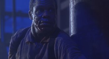 Movie still from “Predator 2” (1990), directed by Stephen Hopkins – A person with a face covered in blood; Close Up shot, Low angle