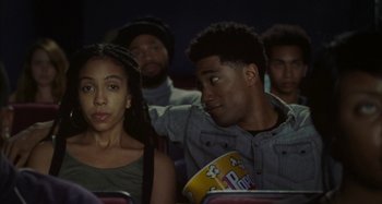 A group of young people sitting in a movie theater