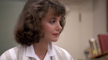 Movie still from “Pretty in Pink” (1986), directed by Howard Deutch – A person wearing a white shirt; Close Up shot, Over the shoulder angle