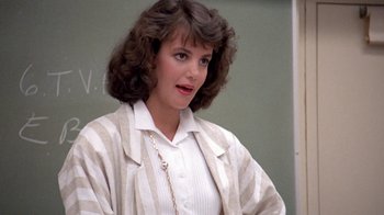 Movie still from “Pretty in Pink” (1986), directed by Howard Deutch – A woman standing in front of a chalkboard; Close Up shot, Over the shoulder angle