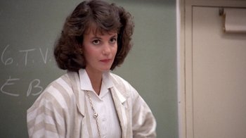 Movie still from “Pretty in Pink” (1986), directed by Howard Deutch – A young woman in a striped shirt and jacket; Close Up shot, Over the shoulder angle