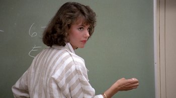 Movie still from “Pretty in Pink” (1986), directed by Howard Deutch – A woman in a striped shirt holding something in her hand; Close Up shot, Over the shoulder angle