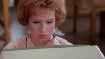 Movie still from “Pretty in Pink” (1986), directed by Howard Deutch – A young woman looking at a computer screen; Close Up shot, Over the shoulder angle