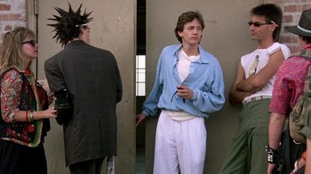Movie still from “Pretty in Pink” (1986), directed by Howard Deutch – A young man standing in front of a group of people; Medium shot, Low angle