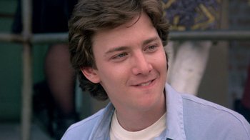 Movie still from “Pretty in Pink” (1986), directed by Howard Deutch – A person wearing a blue shirt; Close Up shot, Low angle