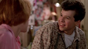 Movie still from “Pretty in Pink” (1986), directed by Howard Deutch – A young man smiles while talking to a young woman; Close Up shot, Over the shoulder angle