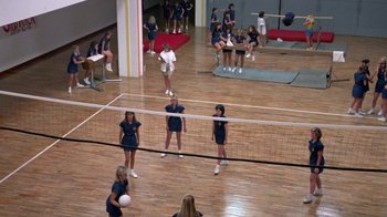 Movie still from “Pretty in Pink” (1986), directed by Howard Deutch – A group of young women playing volleyball in a gymnasium; Wide shot, High angle