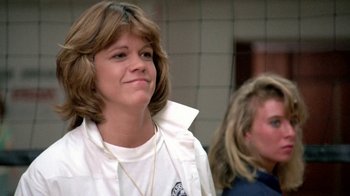 Movie still from “Pretty in Pink” (1986), directed by Howard Deutch – A woman with long brown hair wearing a white t - shirt; Close Up shot, Low angle