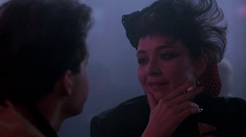 Movie still from “Pretty in Pink” (1986), directed by Howard Deutch – A woman looking in the mirror while touching her face; Close Up shot, Over the shoulder angle