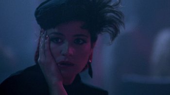 Movie still from “Pretty in Pink” (1986), directed by Howard Deutch – A person wearing a hat and posing for a picture; Close Up shot, Over the shoulder angle