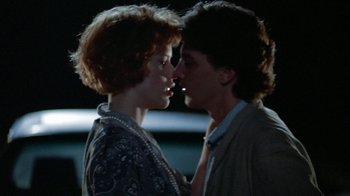Movie still from “Pretty in Pink” (1986), directed by Howard Deutch – A man and a woman are kissing in the dark; Close Up shot, Over the shoulder angle