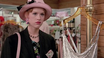 Movie still from “Pretty in Pink” (1986), directed by Howard Deutch – A woman in a pink hat and a black jacket; Close Up shot, Over the shoulder angle