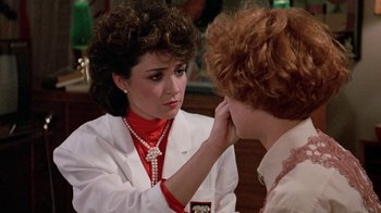 Movie still from “Pretty in Pink” (1986), directed by Howard Deutch – A woman in a white lab coat is looking at another woman in a white lab coat; Close Up shot, Over the shoulder angle