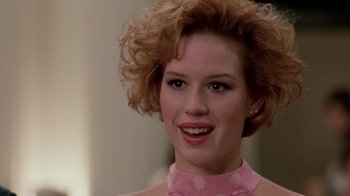 Movie still from “Pretty in Pink” (1986), directed by Howard Deutch – A person wearing a pink shirt; Close Up shot, Over the shoulder angle
