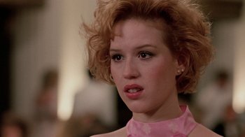 Movie still from “Pretty in Pink” (1986), directed by Howard Deutch – A person wearing a pink shirt; Close Up shot, Over the shoulder angle