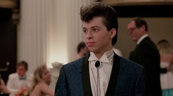 Movie still from “Pretty in Pink” (1986), directed by Howard Deutch – A young man in a suit and tie; Close Up shot, Over the shoulder angle